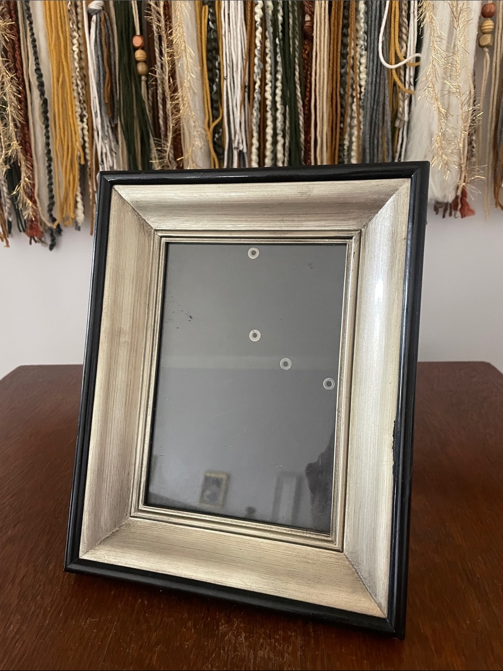 Black and silver tabletop picture frame holds 5x7
